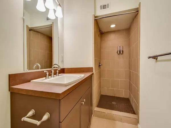 a bathroom with a sink and a shower