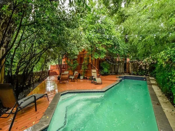 a view of a house with swimming pool and sitting area