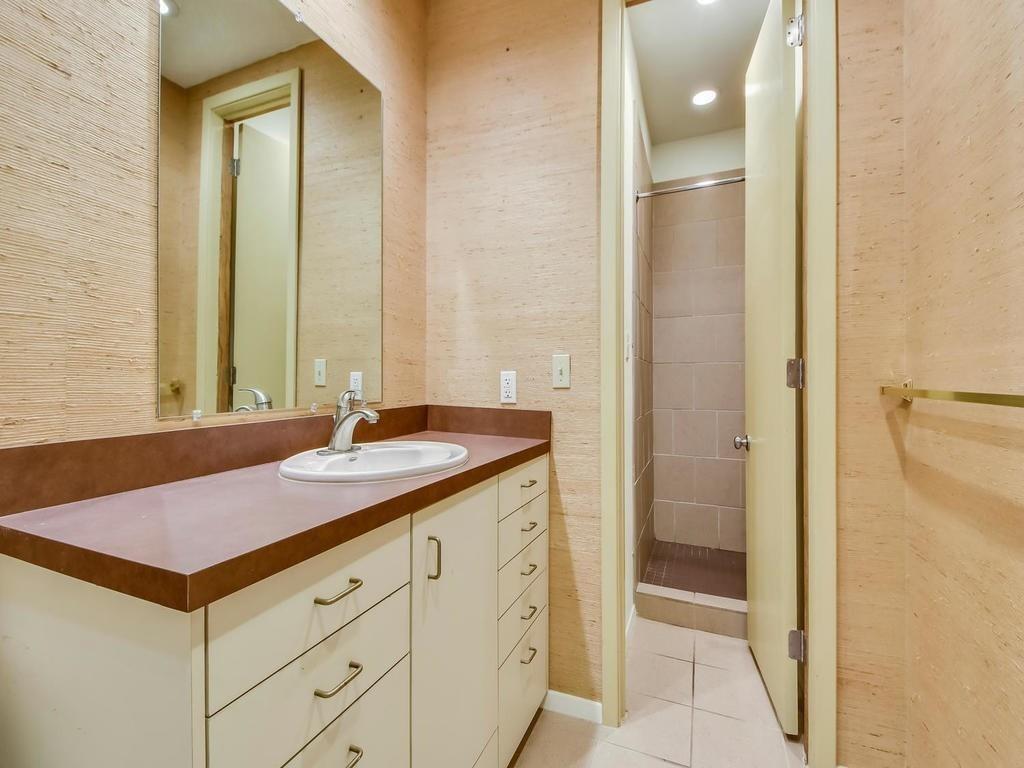 800 Leonard Street Austin, TX 78705 - Photo 23 of 31 a bathroom with a granite countertop sink and a mirror