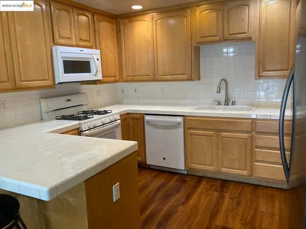 a kitchen with sink cabinets and wooden floor