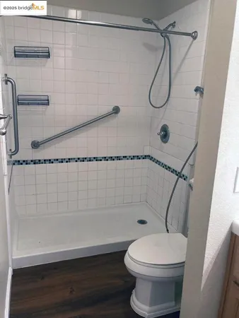 a bathroom with a shower a toilet and a shower