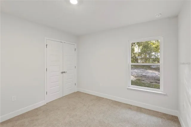 wooden floor in an empty room with a ceiling fan