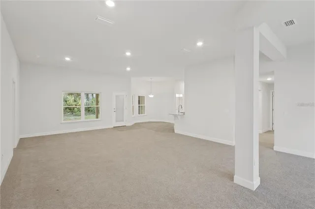 a spacious bathroom with a granite countertop tub sink and mirror
