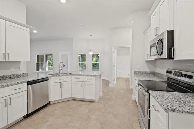 a kitchen with a sink stove and cabinets
