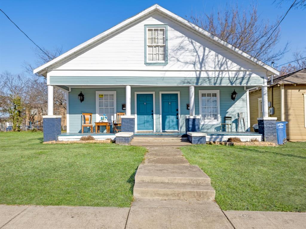 a front view of a house with swimming pool patio and yard