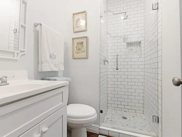 a bathroom with a sink a toilet and shower