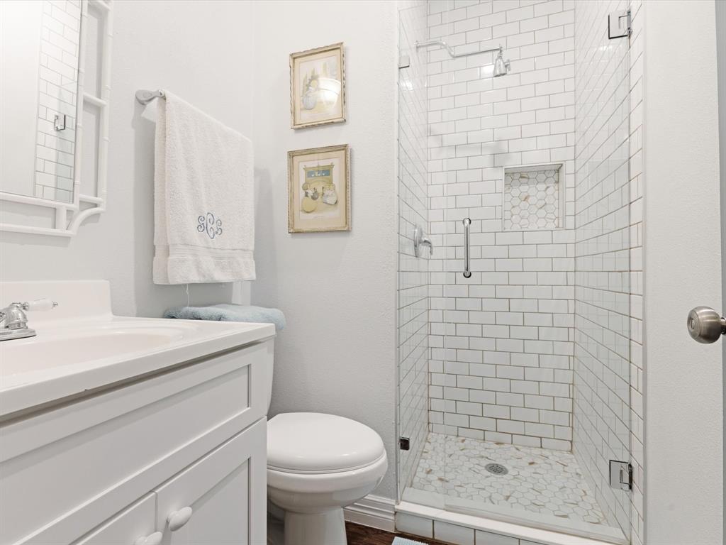 222 North Cliff Street Dallas, TX 75203 - Photo 11 of 14 a bathroom with a sink a toilet and shower
