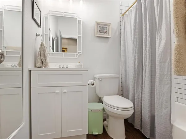 a bathroom with a toilet a sink and a mirror