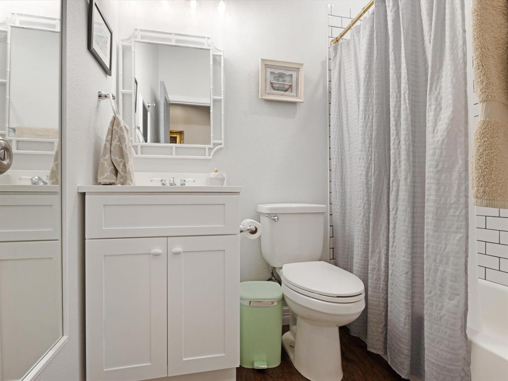 222 North Cliff Street Dallas, TX 75203 - Photo 12 of 14 a bathroom with a toilet a sink and a mirror