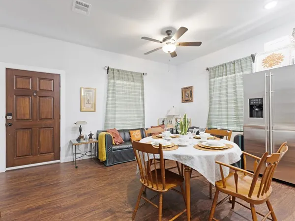a dining room with furniture wooden floor and a window