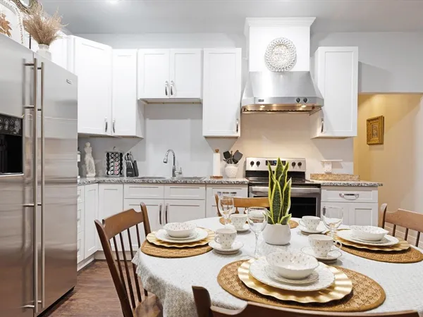 a kitchen with a dining table and chairs