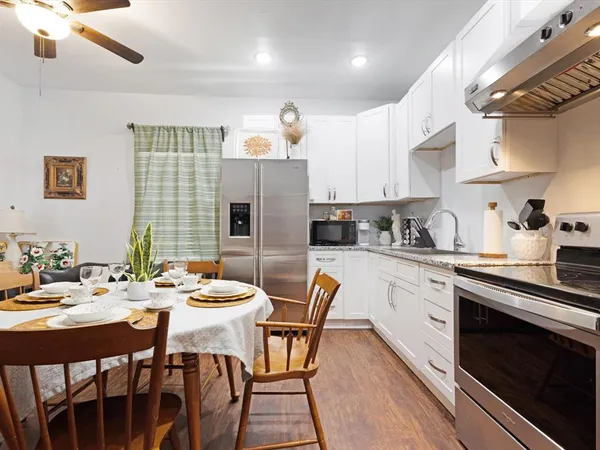 a kitchen that has a table and chairs in it
