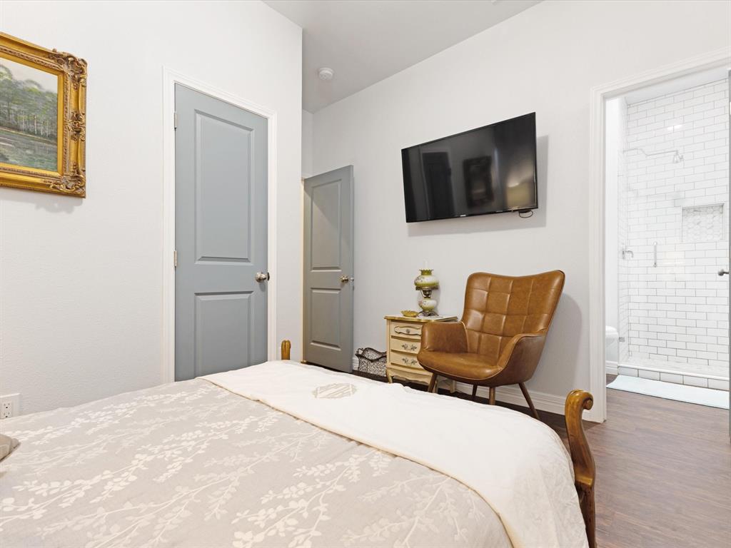 222 North Cliff Street Dallas, TX 75203 - Photo 9 of 14 a bedroom with a bed and flat screen tv