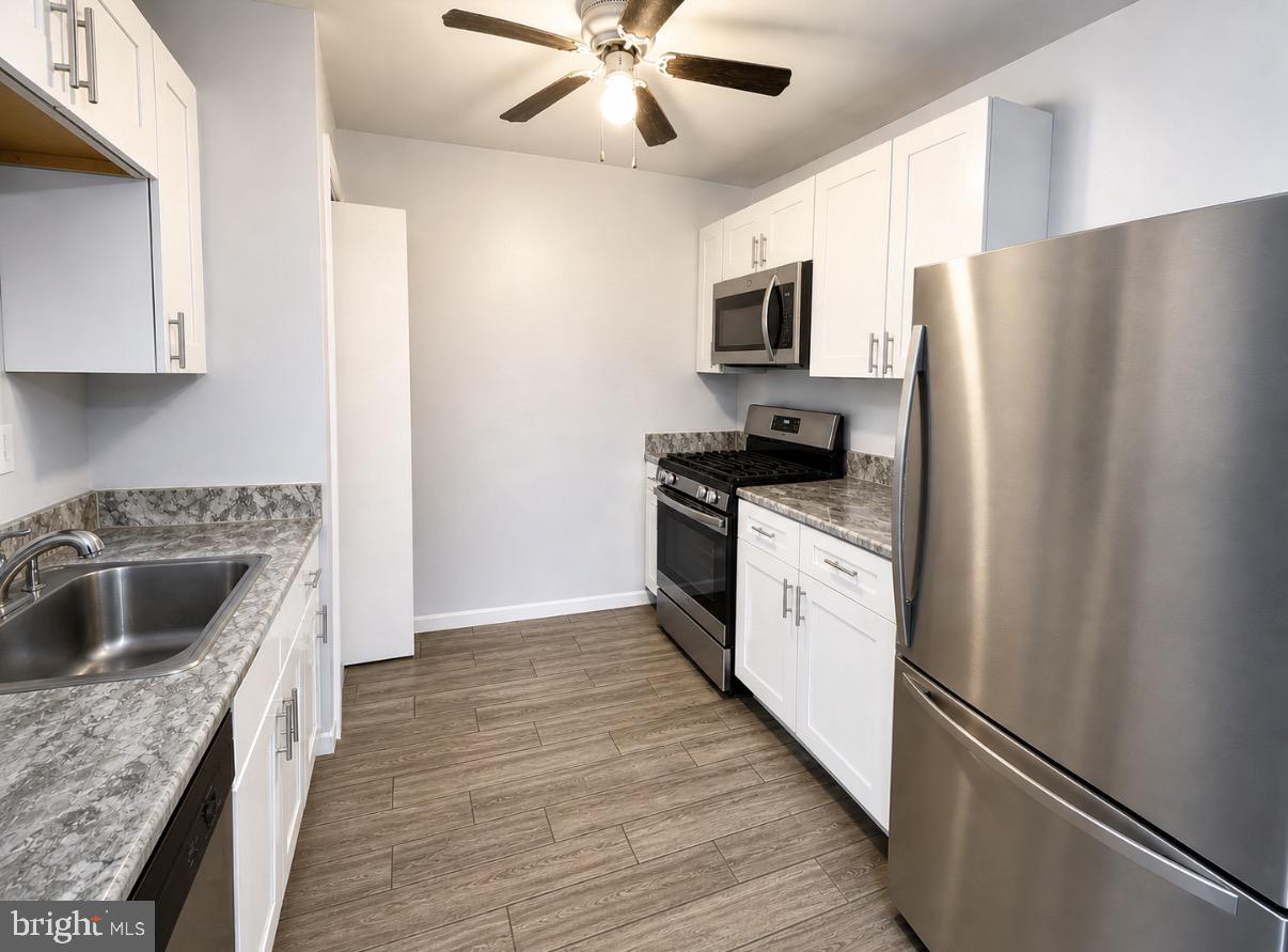 3129 Comly Road Philadelphia, PA 19154 - Photo 3 of 7 a kitchen with stainless steel appliances granite countertop a stove a sink and a refrigerator