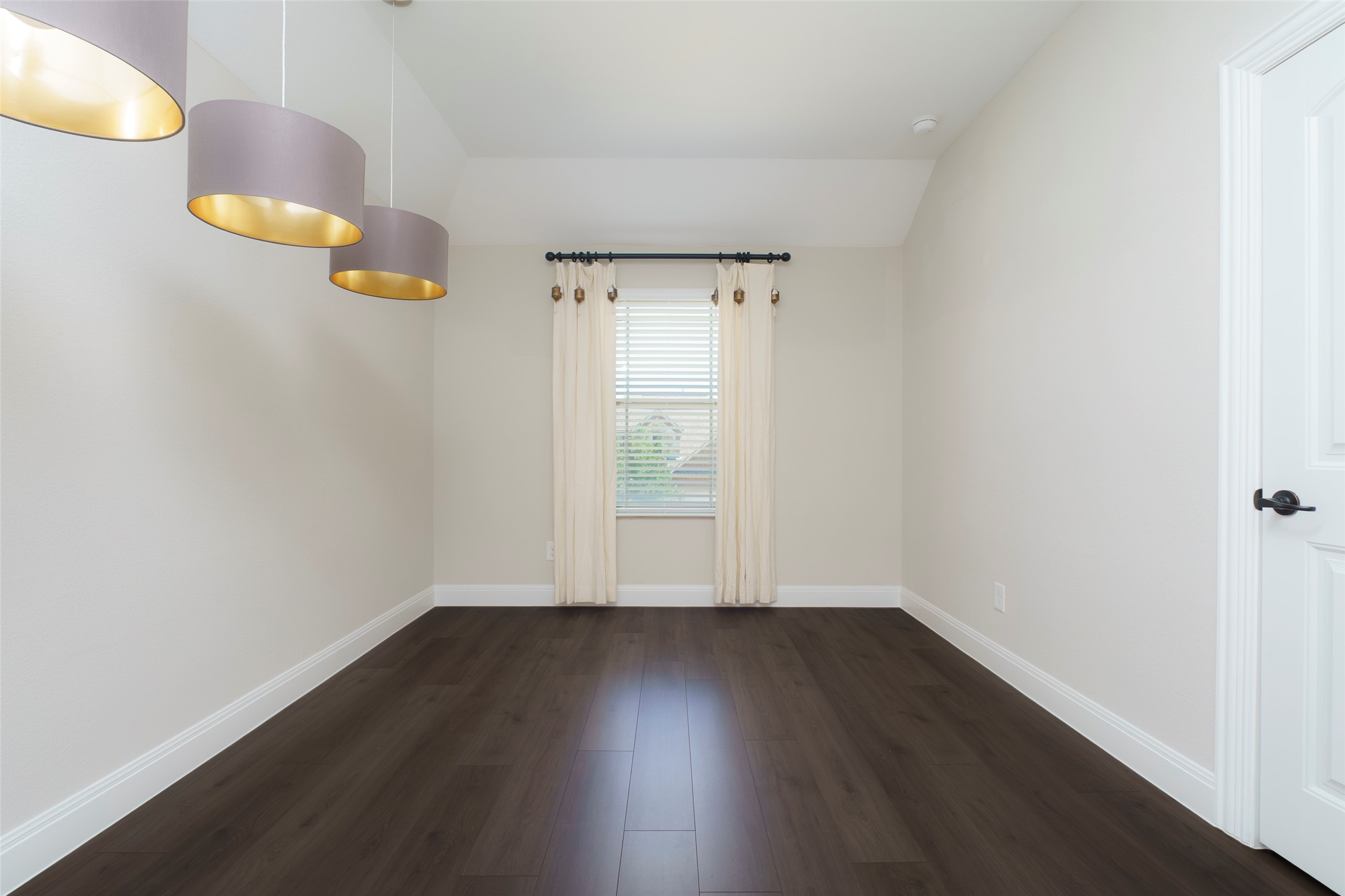 2305 Millbrook Loop Leander, TX 78641 - Photo 15 of 26 Rich dark wood flooring anchors this versatile space, bathed in natural light from a well-appointed window.
