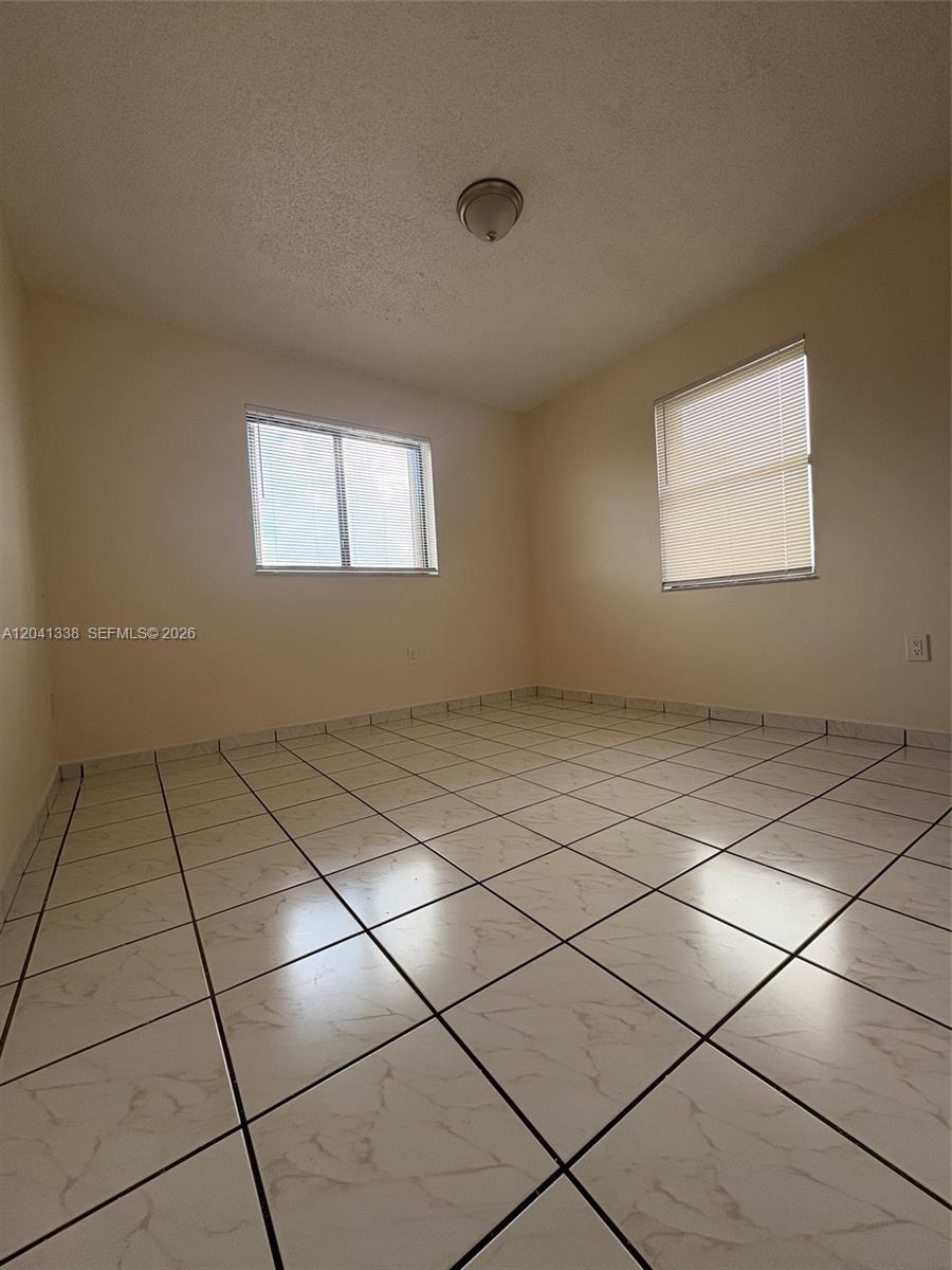 231 East 7th Street, Unit 202 Hialeah, FL 33010 - Photo 6 of 7 a view of an empty room and window