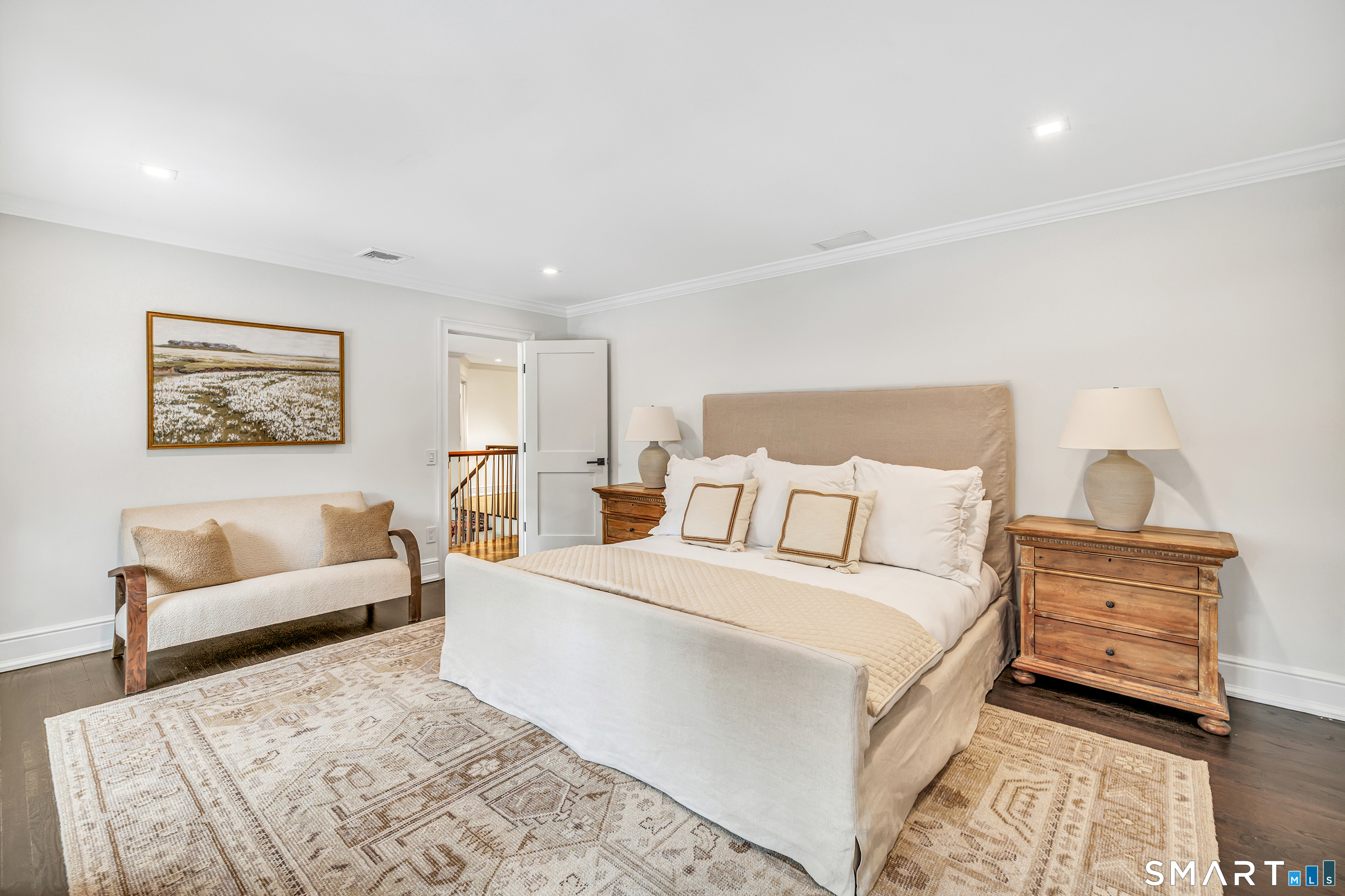 200 Longmeadow Road Fairfield, CT 06824 - Photo 29 of 40 a spacious bedroom with a bed a couch and a couch