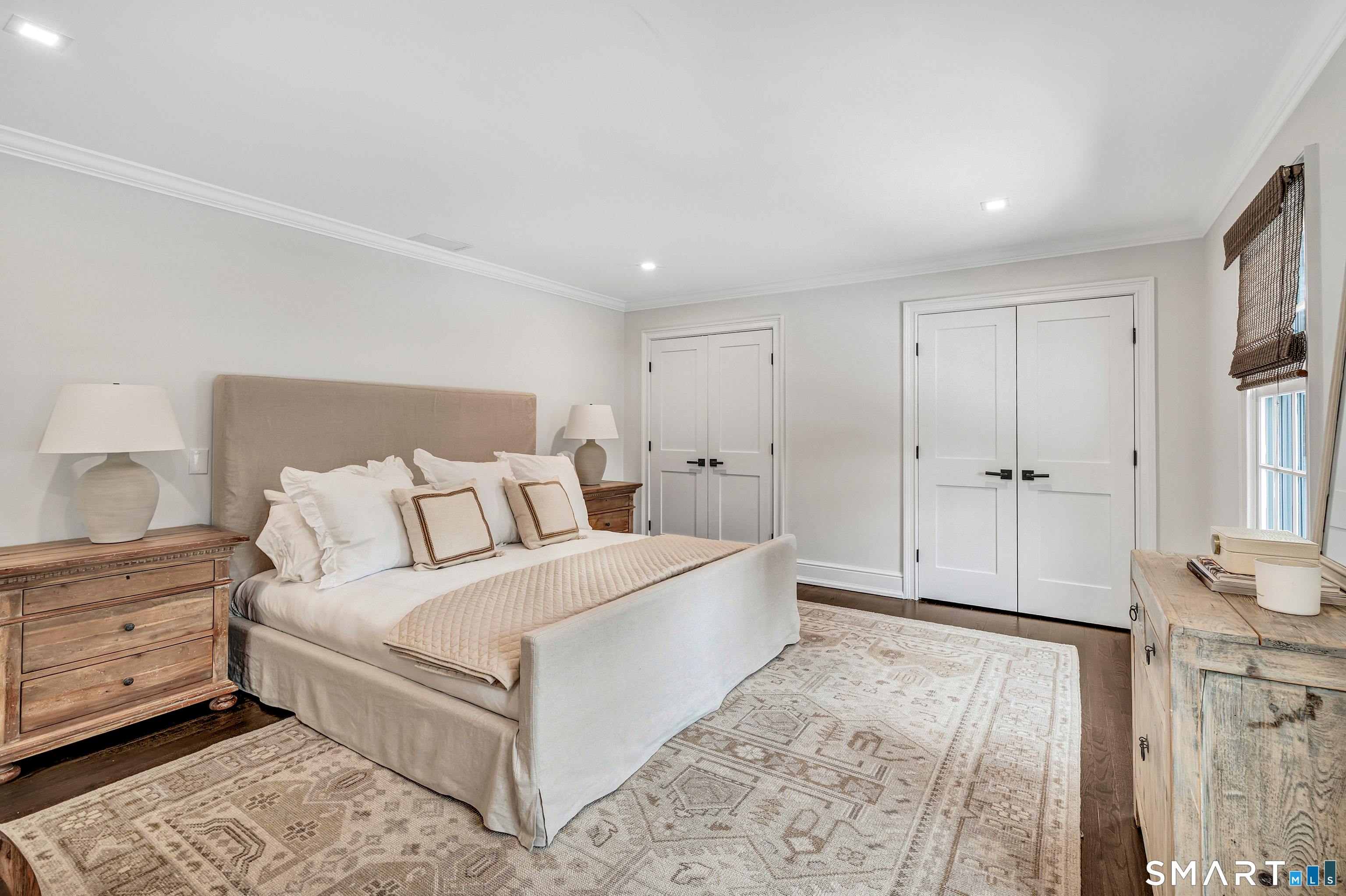 200 Longmeadow Road Fairfield, CT 06824 - Photo 30 of 40 a spacious bedroom with a bed and a couch