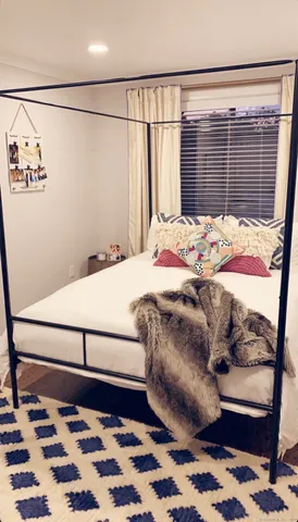 a bedroom with furniture and wooden floor