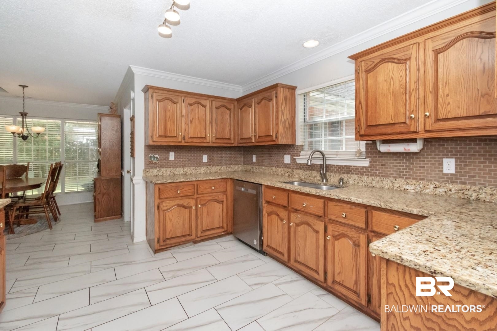 9991 Wedgefield Court Mobile, AL 36608 - Photo 7 of 30 Kitchen featuring stainless steel dishwasher, sink, a wealth of natural light, and decorative light fixtures