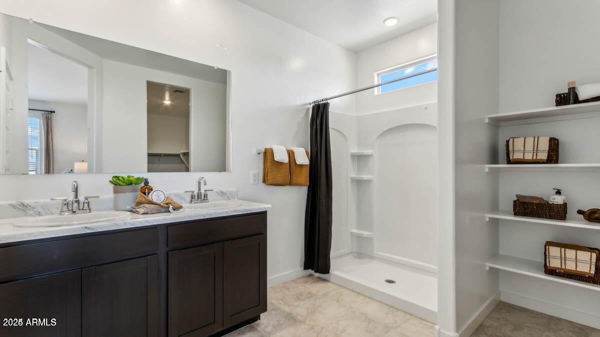 5447 East Axle Lane San Tan Valley, AZ 85140 - Photo 13 of 16 a en suite bathroom with a double vanity sink and a mirror