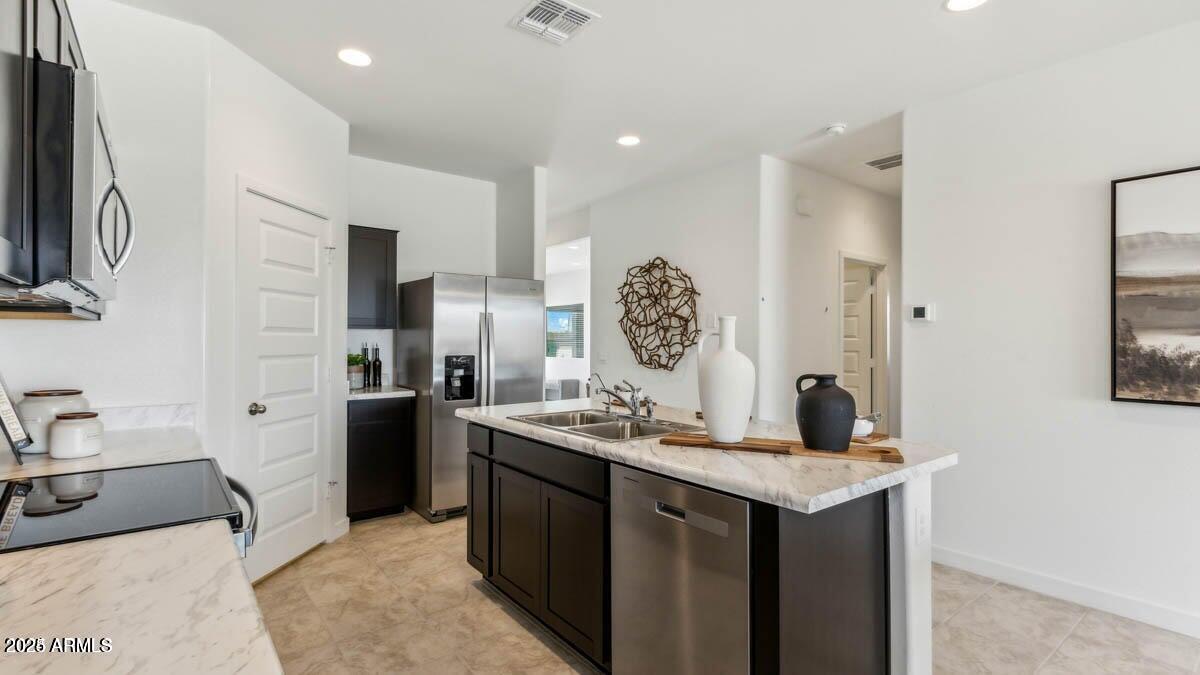 5447 East Axle Lane San Tan Valley, AZ 85140 - Photo 3 of 16 a kitchen with a sink stove and refrigerator