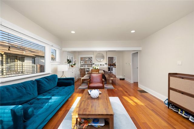 a living room with furniture fireplace and a window