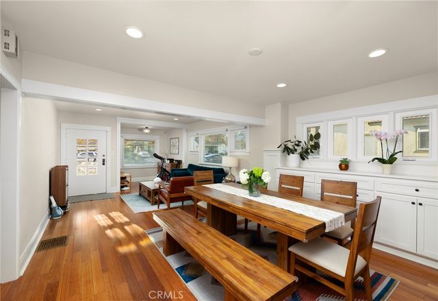 a living room with furniture a table and wooden floor