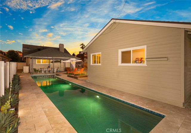 a house with swimming pool in front of it