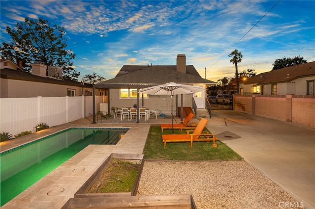 a view of a backyard with sitting area