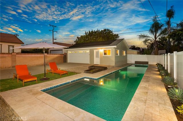 swimming pool view with a seating space