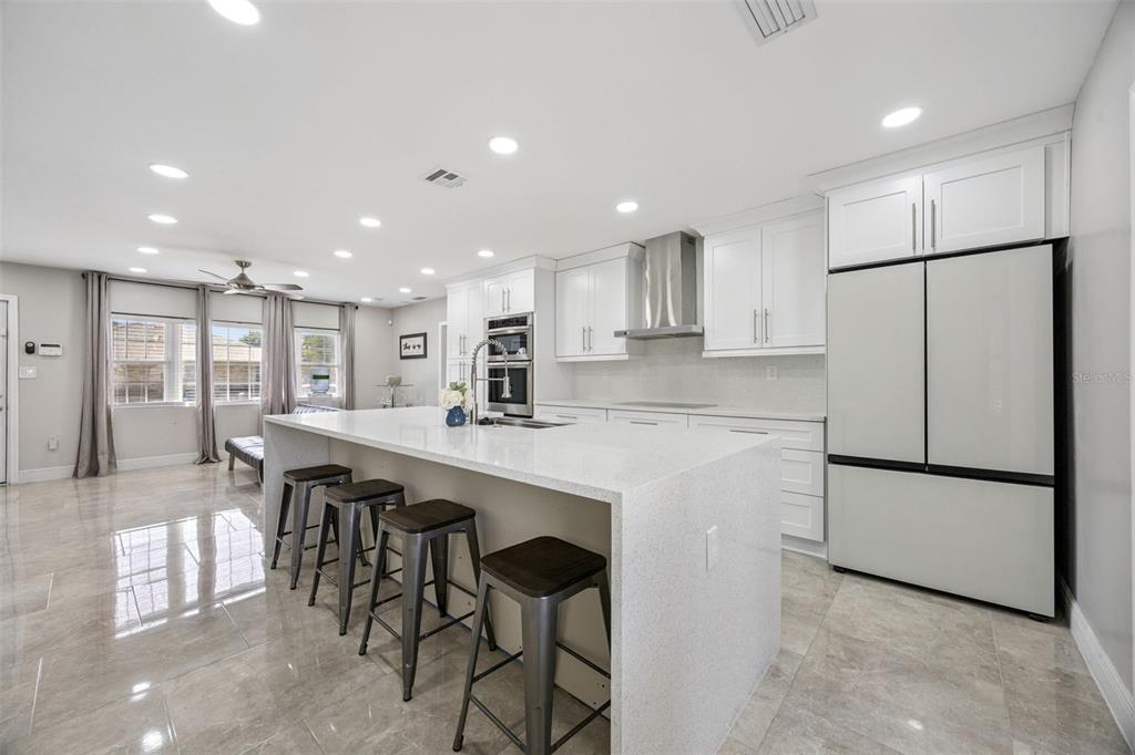 700 9th Street St. Cloud, FL 34769 - Photo 13 of 78 a kitchen with kitchen island white cabinets and stainless steel appliances