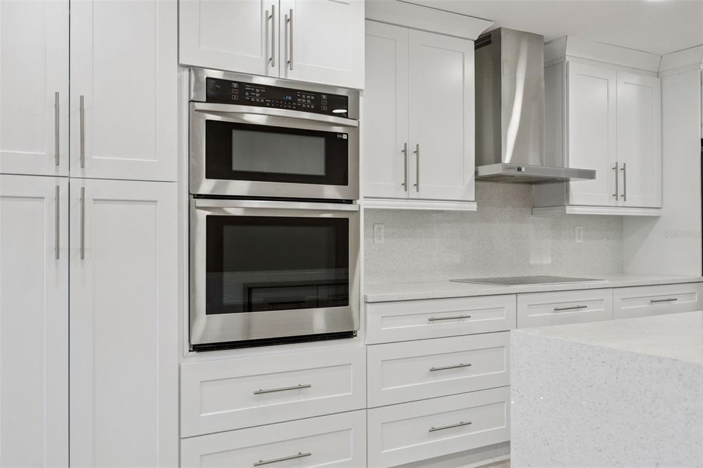 700 9th Street St. Cloud, FL 34769 - Photo 17 of 78 a kitchen with granite countertop white cabinets stainless steel appliances and sink