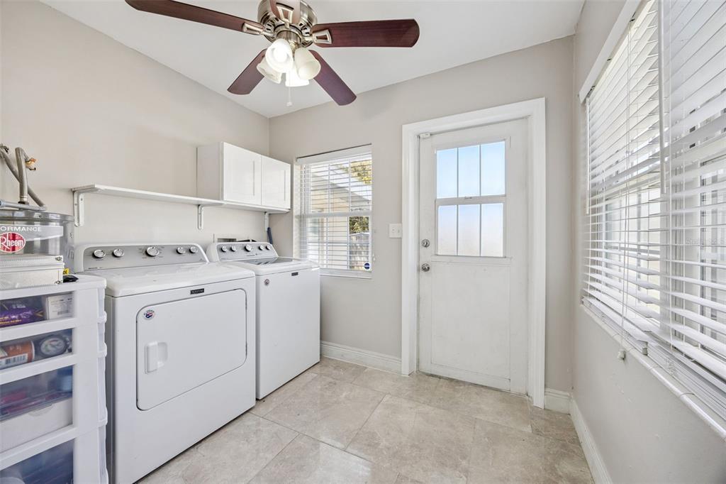 700 9th Street St. Cloud, FL 34769 - Photo 21 of 78 a room with white cabinets and white appliances