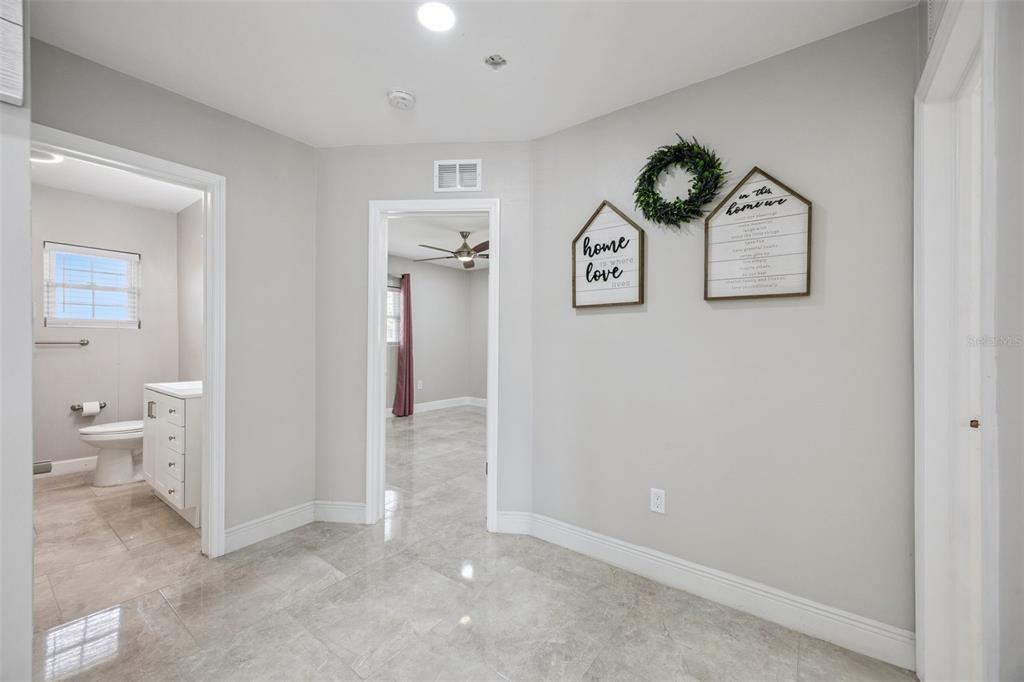 700 9th Street St. Cloud, FL 34769 - Photo 22 of 78 a view of a hallway with bathroom