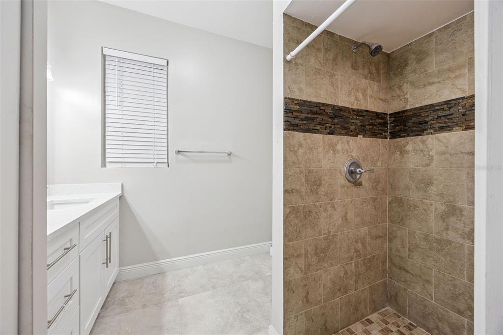 700 9th Street St. Cloud, FL 34769 - Photo 26 of 78 a bathroom with a shower and a sink