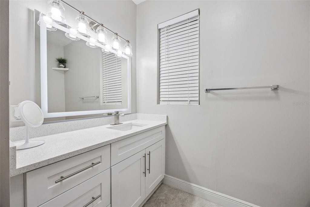 700 9th Street St. Cloud, FL 34769 - Photo 29 of 78 a bathroom with a sink and a mirror