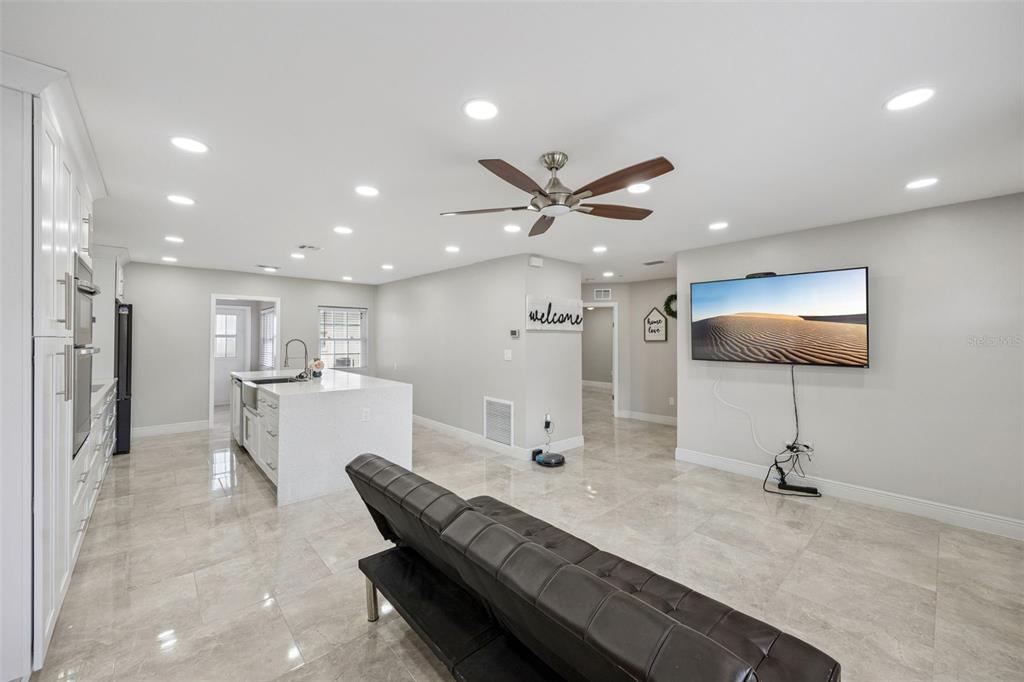 700 9th Street St. Cloud, FL 34769 - Photo 8 of 78 a living room with furniture and a view of kitchen