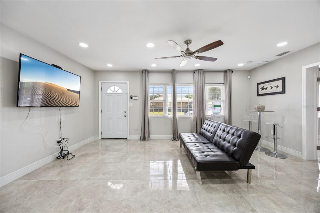 700 9th Street St. Cloud, FL 34769 - Photo 9 of 78 a living room with furniture and a flat screen tv