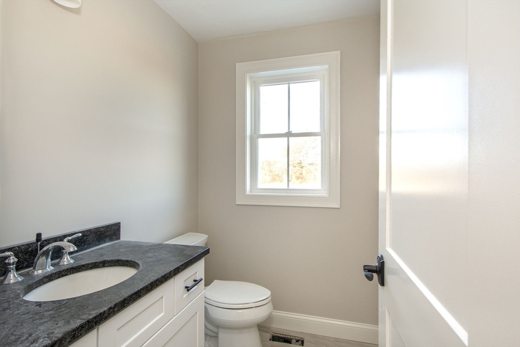 548 Harvard Street Whitman, MA 02382 - Photo 14 of 37 a bathroom with a granite countertop sink toilet and a mirror