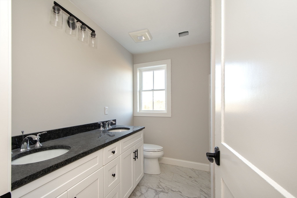 548 Harvard Street Whitman, MA 02382 - Photo 29 of 37 a bathroom with a granite countertop sink and a mirror