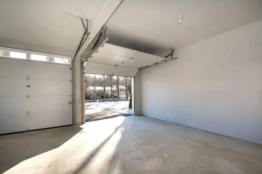 a view of a big room with wooden floor and windows