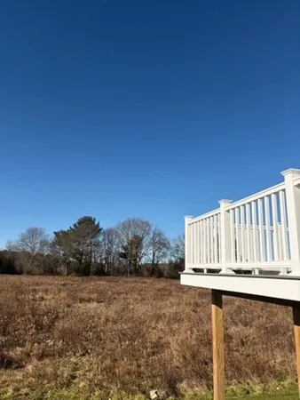 a view of a backyard with wooden fence