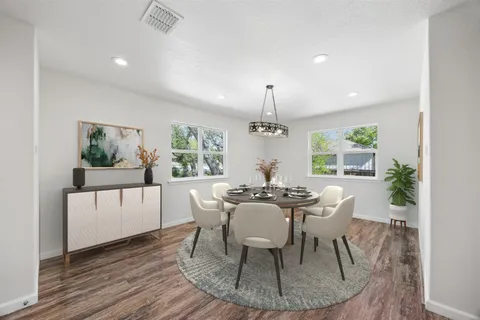 a view of a dining room with furniture window and wooden floor