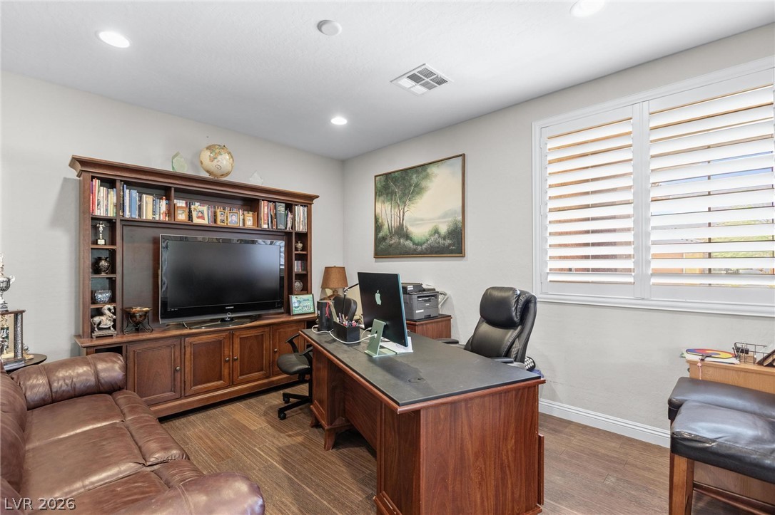 8431 Durango Ranch Court Las Vegas, NV 89113 - Photo 16 of 49 An inviting home office with wood flooring and built-in features awaits your productivity.
