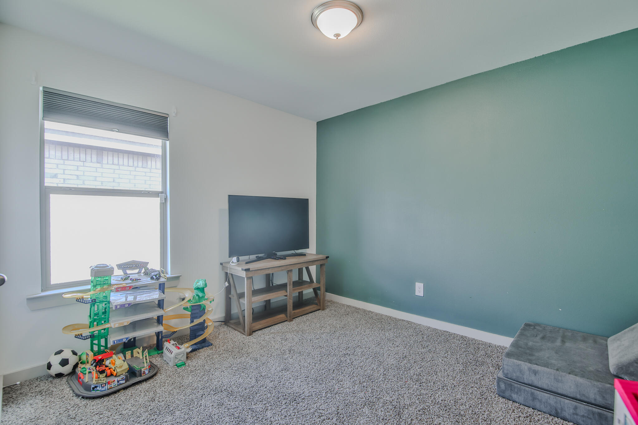 7406 9th Street Lubbock, TX 79416 - Photo 16 of 54 a view of a livingroom with furniture and a flat screen tv