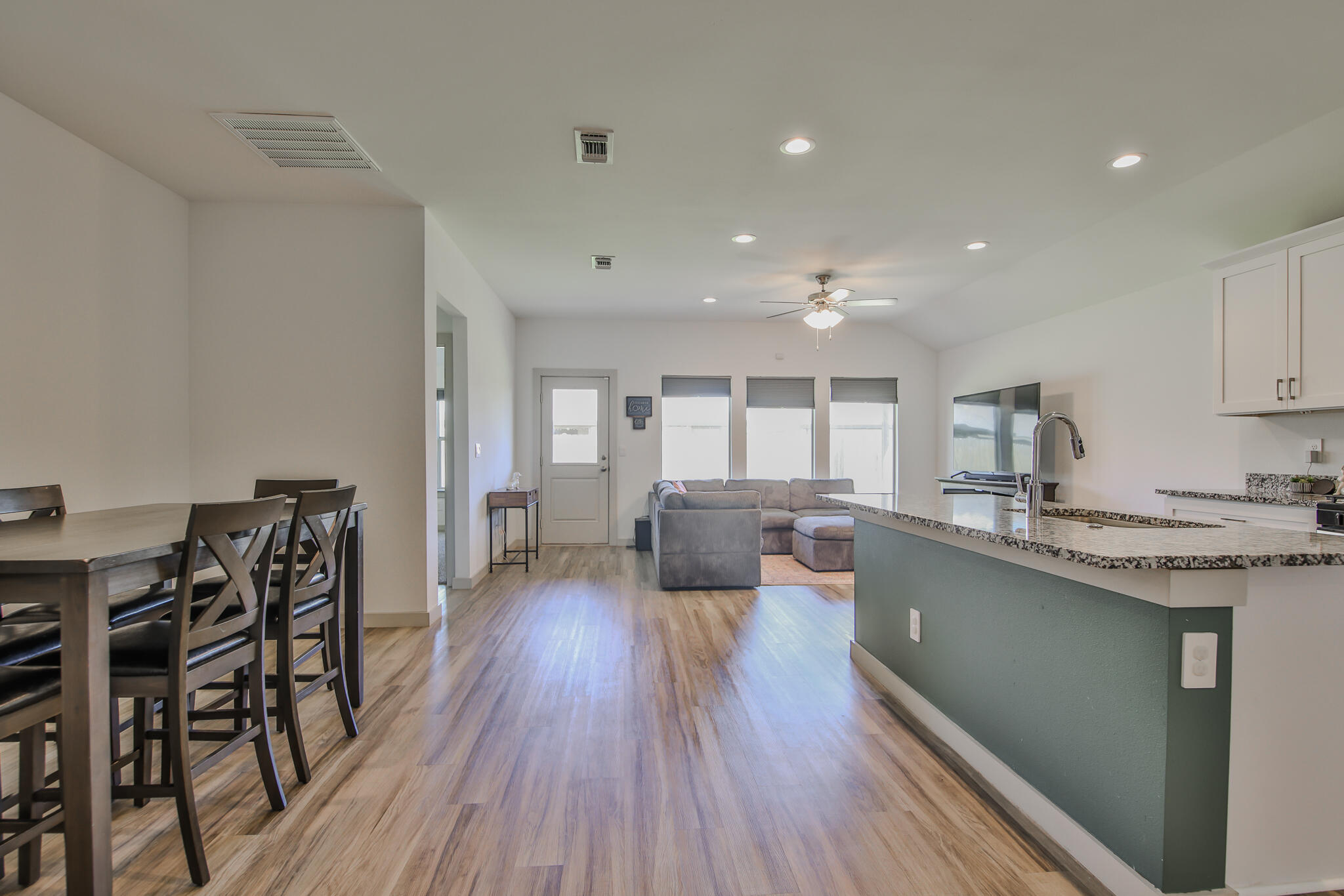 7406 9th Street Lubbock, TX 79416 - Photo 21 of 54 a kitchen with counter space dining table and chairs