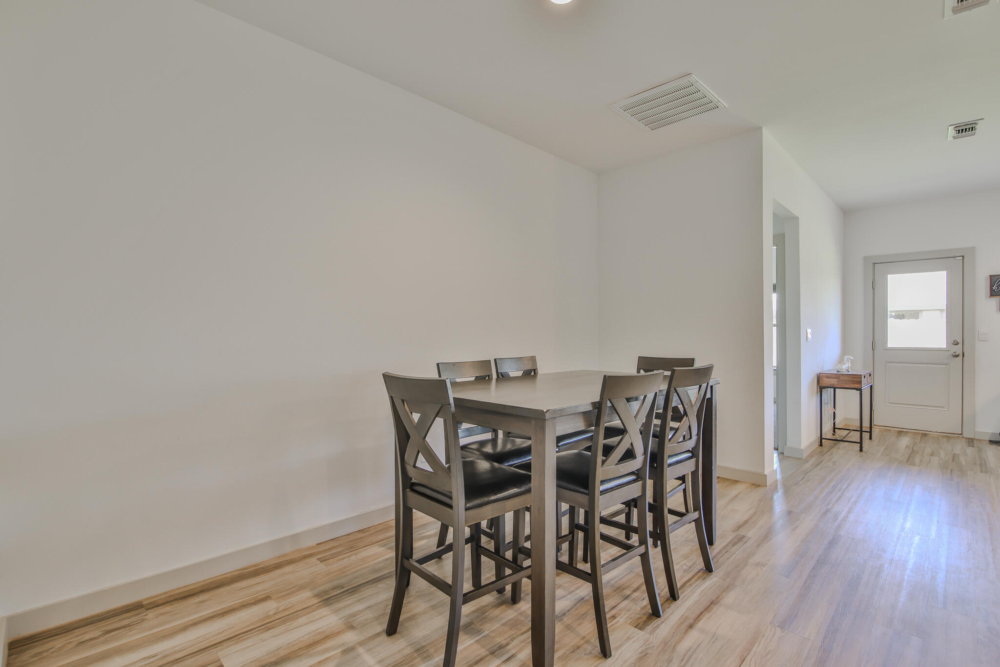 7406 9th Street Lubbock, TX 79416 - Photo 23 of 54 a view of a dining room with furniture and wooden floor