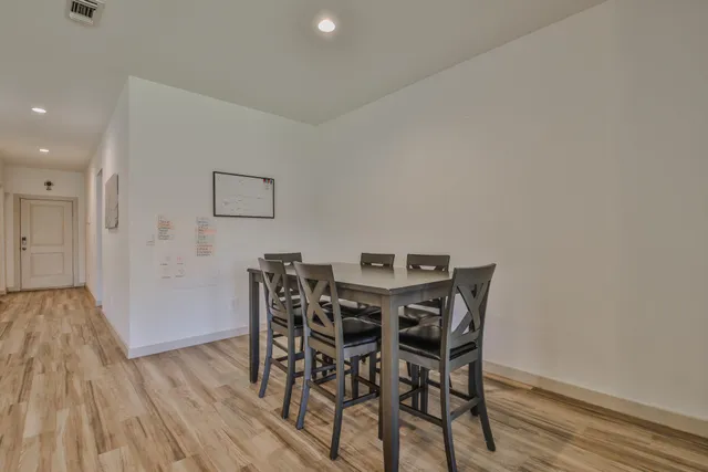 a kitchen with stainless steel appliances granite countertop wooden cabinets a stove a sink and a microwave