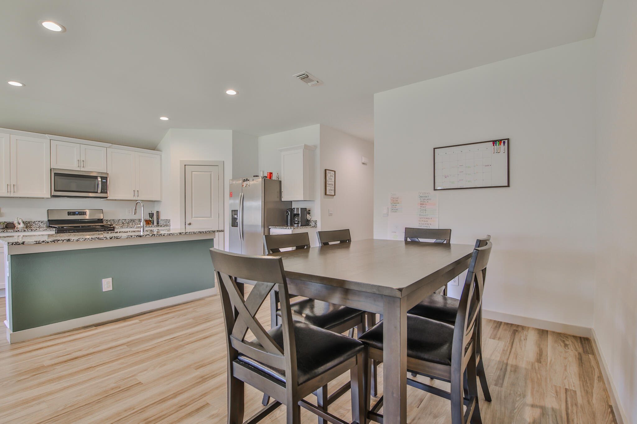 7406 9th Street Lubbock, TX 79416 - Photo 26 of 54 a view of a dining room with furniture and wooden floor